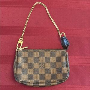 Louis Vuitton mini pochette damier canvas
Like New without tags.